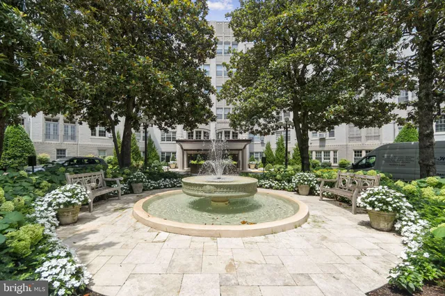 a view of a fountain in the backyard of house
