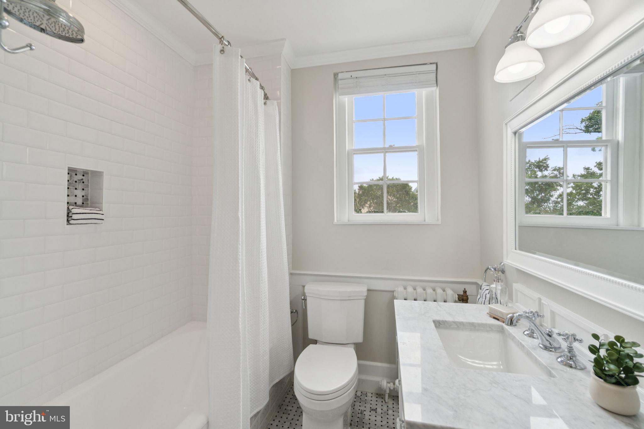 2737 Devonshire Place Northwest, Unit 503 Washington, DC 20008 - Photo 28 of 49 a white toilet sitting next to a bathroom sink