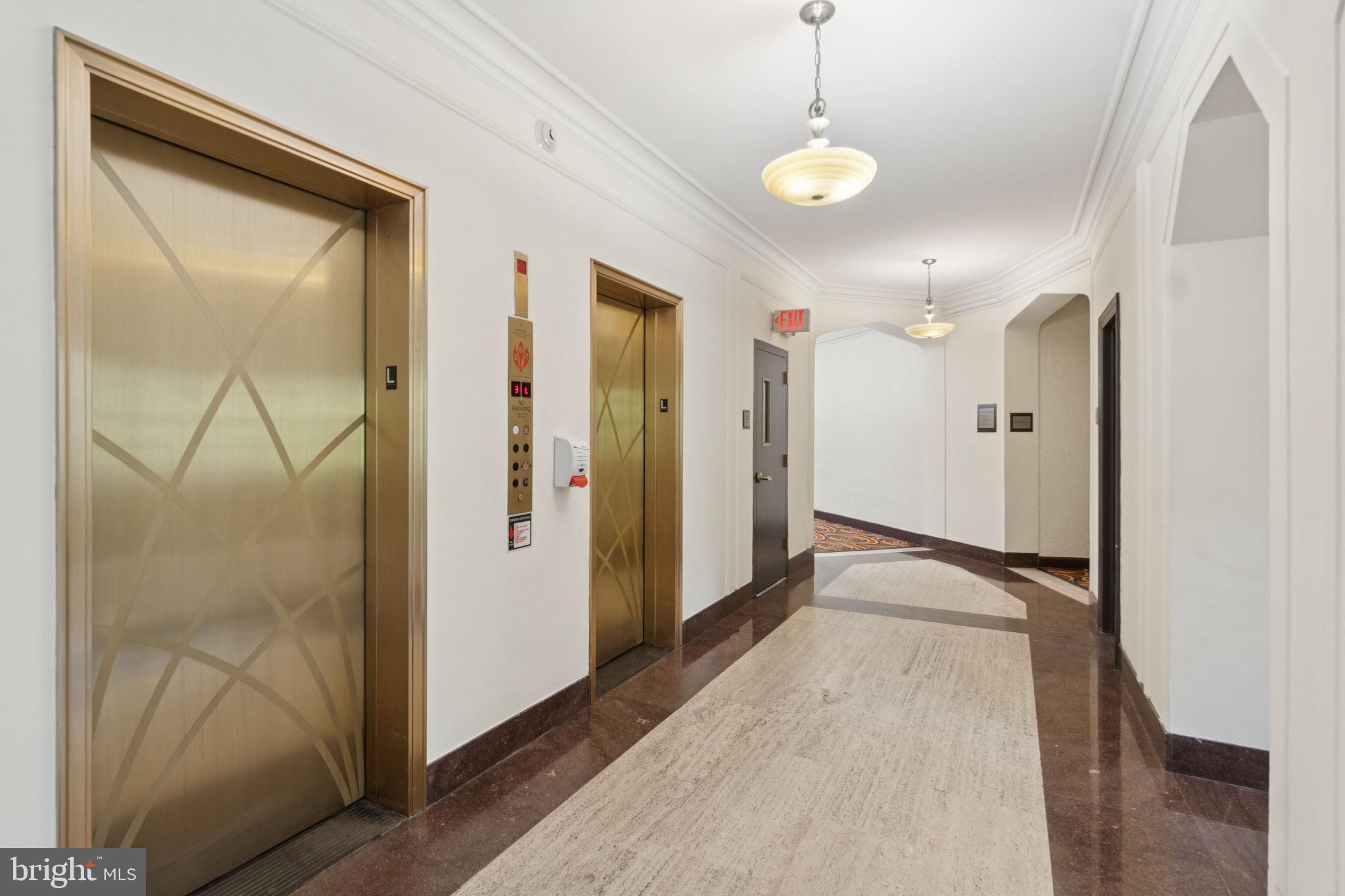 2737 Devonshire Place Northwest, Unit 503 Washington, DC 20008 - Photo 44 of 49 a view of a hallway with wooden floor and glass door