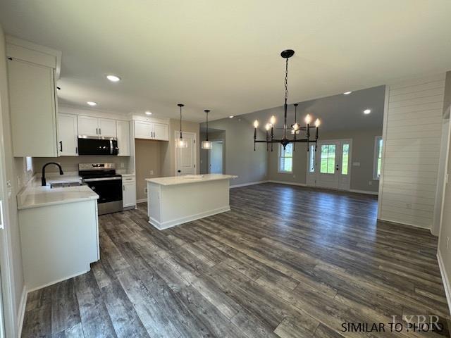 600 Stratford Road Concord, VA 24538 - Photo 5 of 15 a view of a kitchen with granite countertop a stove top oven a sink and a chandelier