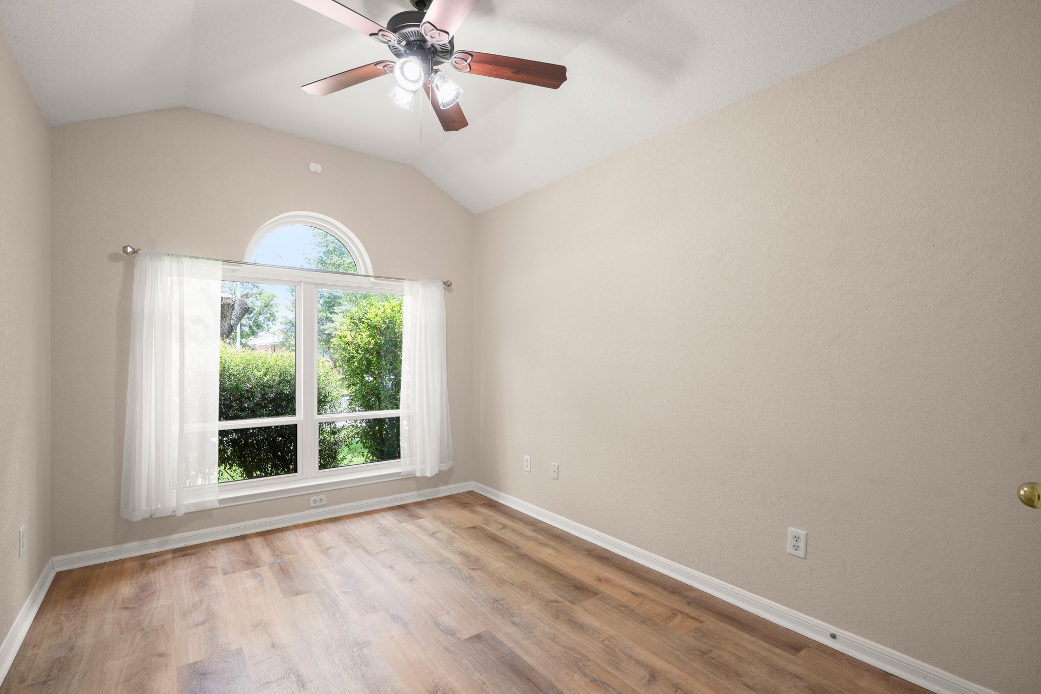 438 Katy Crossing Georgetown, TX 78626 - Photo 17 of 24 A quiet room featuring vaulted ceilings and abundant natural light from the large window.