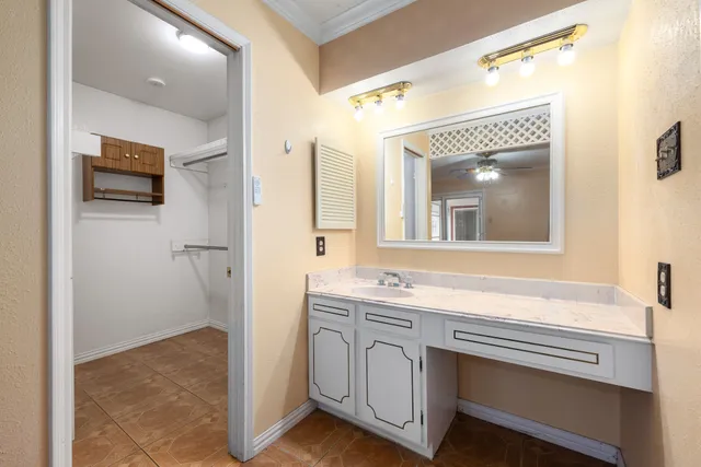 a bathroom with a sink a mirror a vanity and a shower