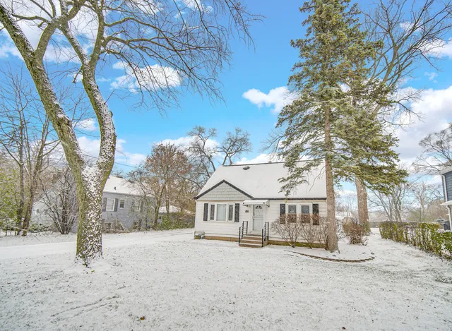 a view of a house with a snow in the yard