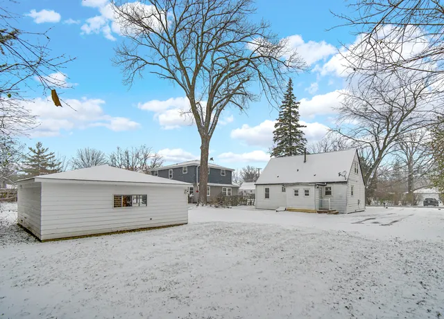 a view of a house with snow in front of it