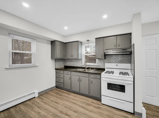 a kitchen with stainless steel appliances granite countertop a stove and a refrigerator
