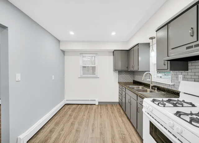 a kitchen with a stove a sink and a refrigerator