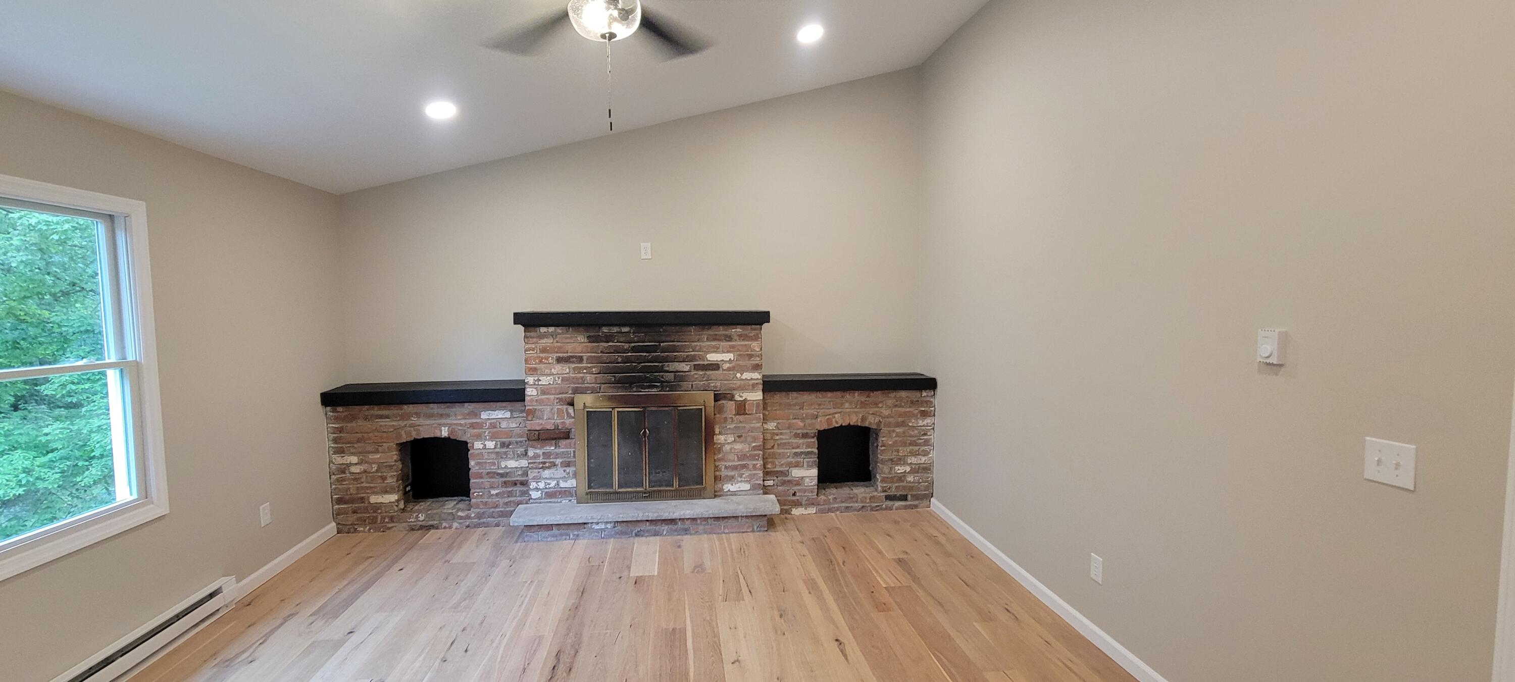 1183 Falls Road Bushkill, PA 18324 - Photo 32 of 47 Brick-Faced Fireplace in Primary Bedroom
