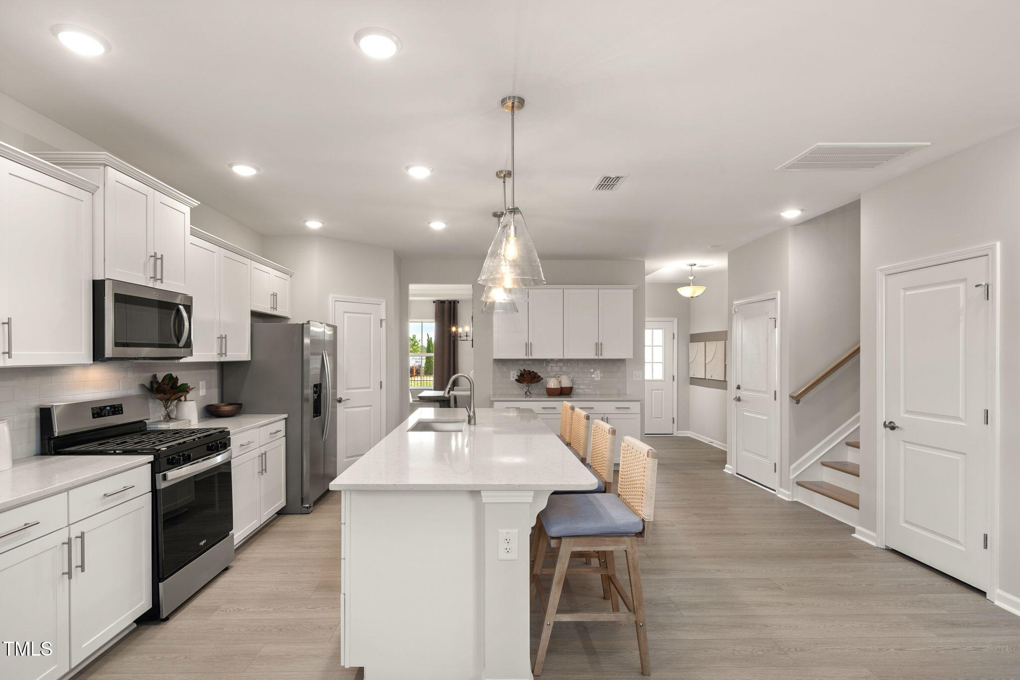 700 Ben Ledi Court Raleigh, NC 27603 - Photo 2 of 30 a large white kitchen with lots of counter space a refrigerator cabinets and a sink