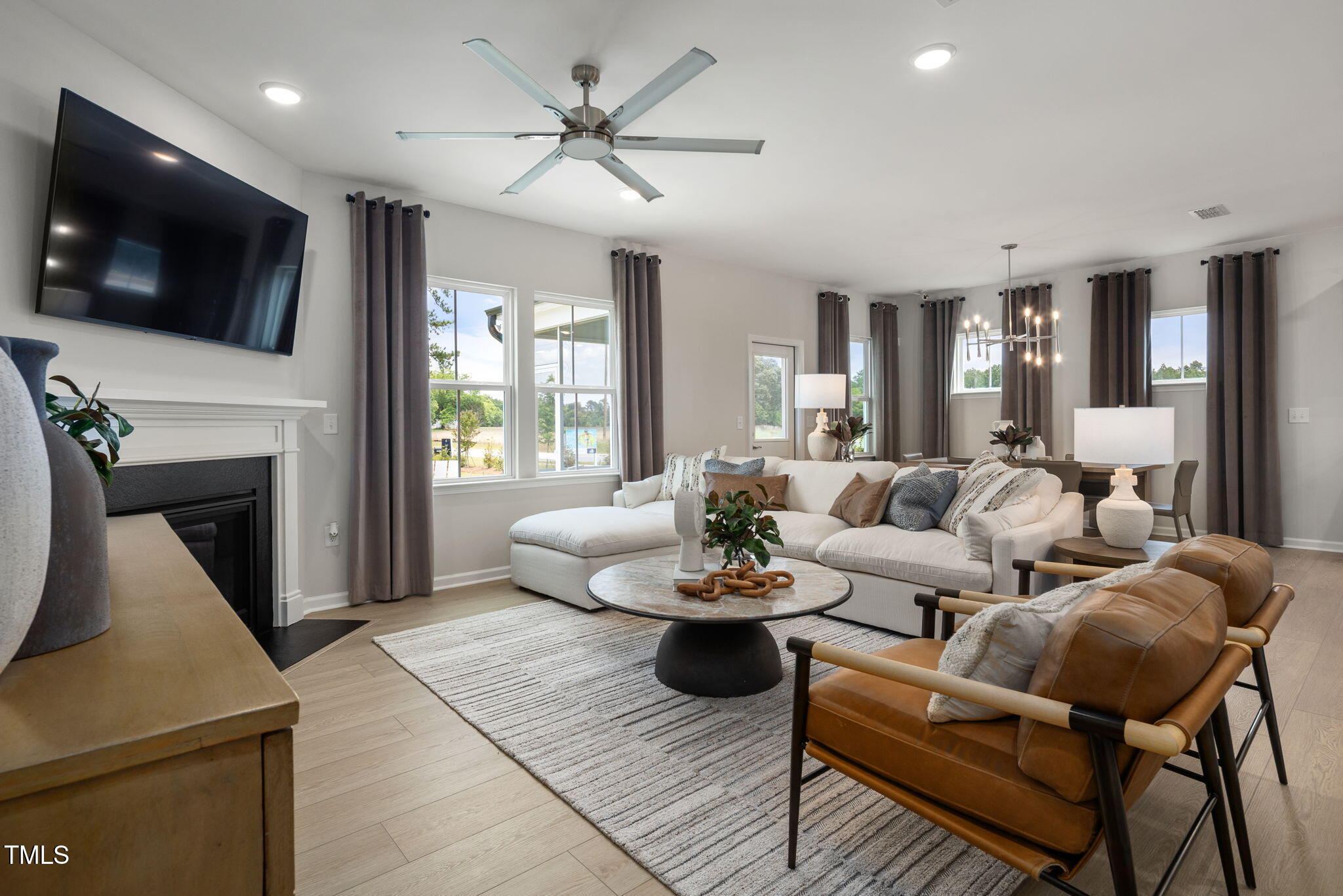 700 Ben Ledi Court Raleigh, NC 27603 - Photo 7 of 30 a living room with furniture a flat screen tv and a fireplace