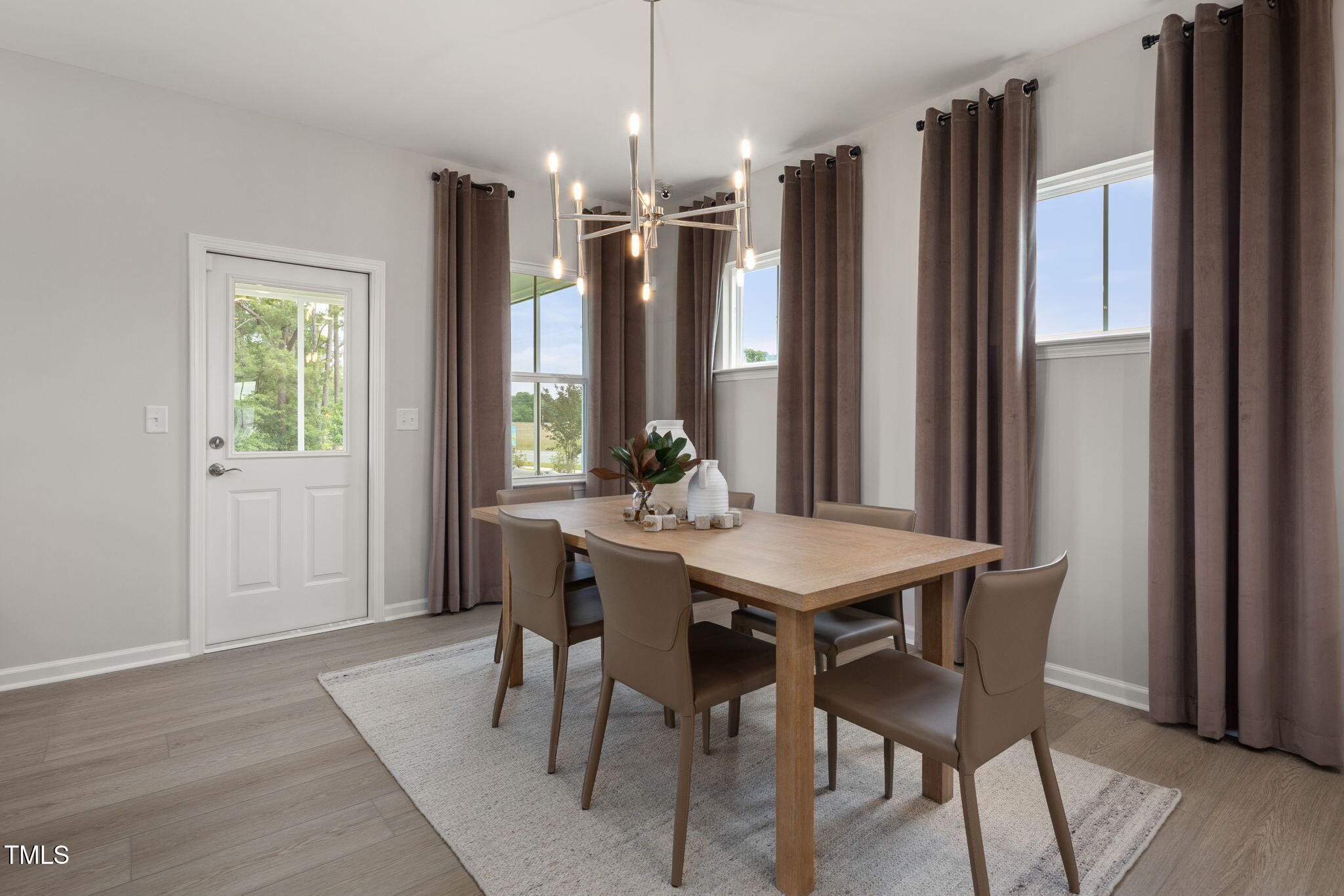 700 Ben Ledi Court Raleigh, NC 27603 - Photo 8 of 30 a view of a dining room with furniture window and wooden floor