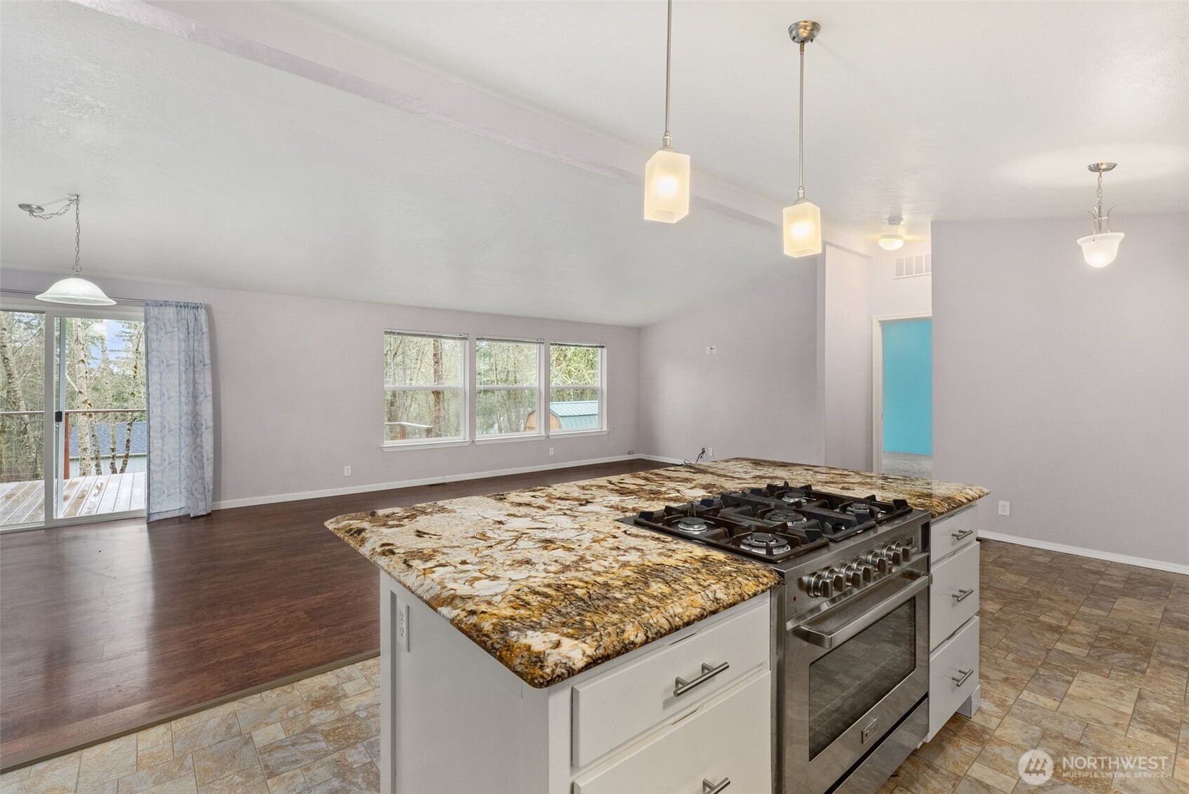 126 Burchett Road Onalaska, WA 98570 - Photo 11 of 36 a kitchen that has a stove and a wooden floor