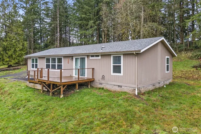 a view of a house with a yard and deck