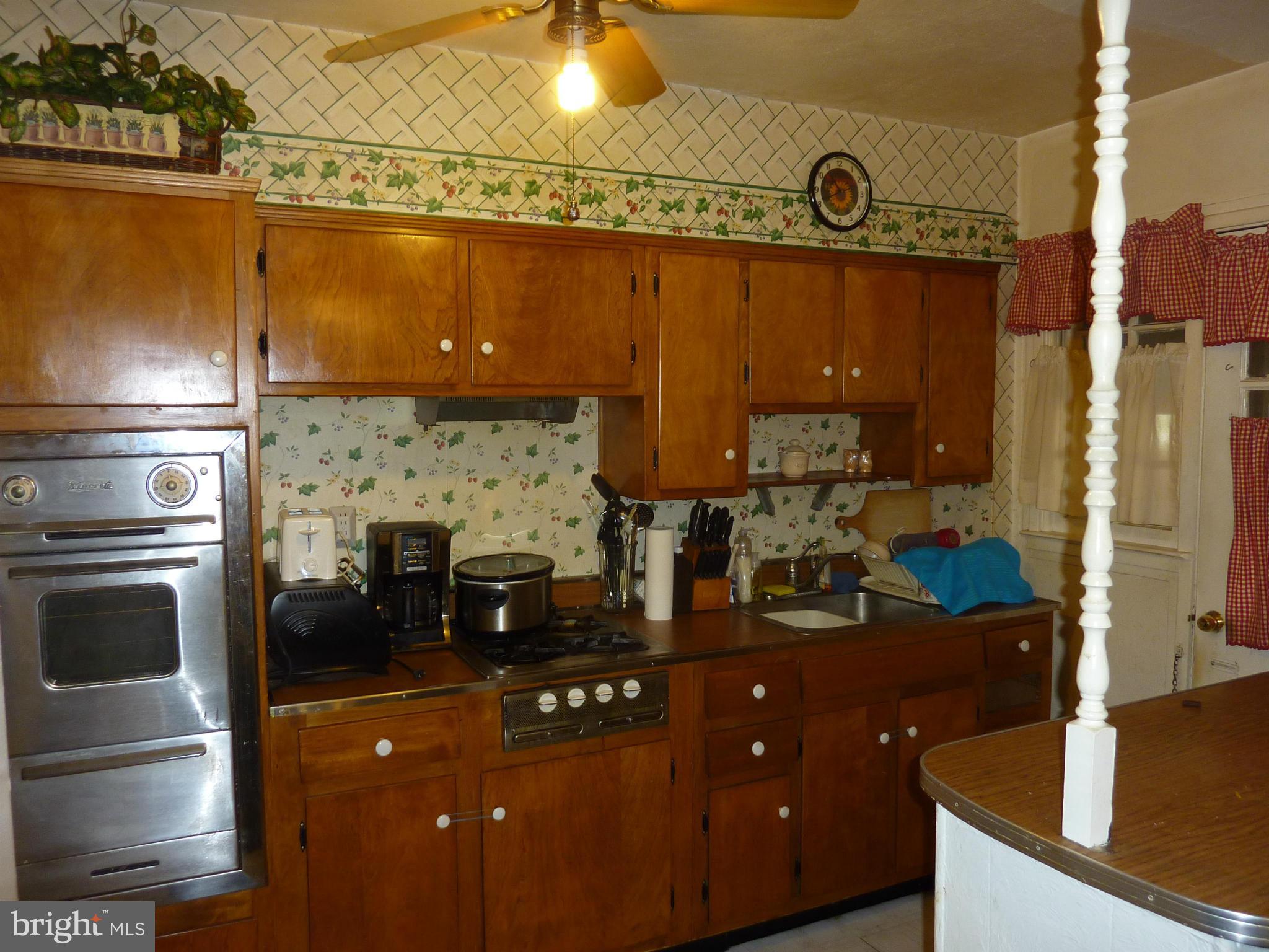 8019 Charlesmont Road Baltimore, MD 21222 - Photo 11 of 25 a kitchen with a refrigerator and a sink