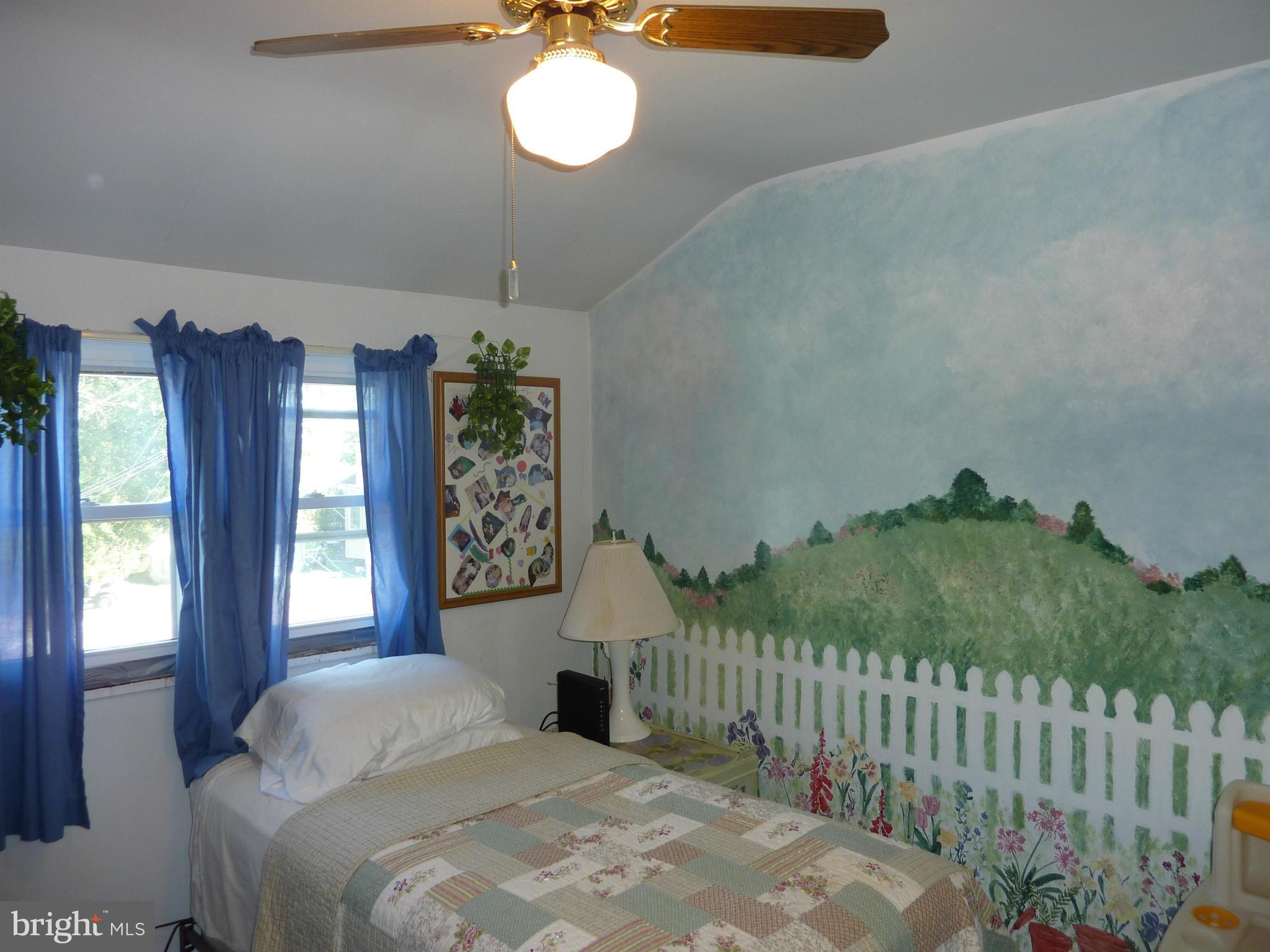 8019 Charlesmont Road Baltimore, MD 21222 - Photo 13 of 25 a bedroom with a bed and a window