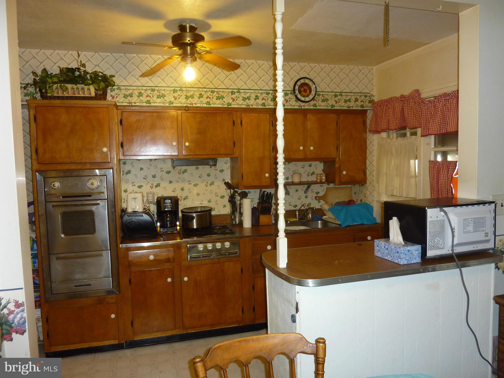 8019 Charlesmont Road Baltimore, MD 21222 - Photo 10 of 25 a kitchen with a refrigerator and a stove