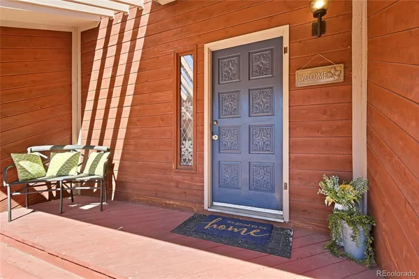 a view of an entryway with wooden floor and stairs