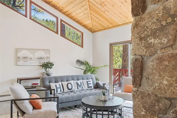 a living room with fireplace furniture and a fireplace