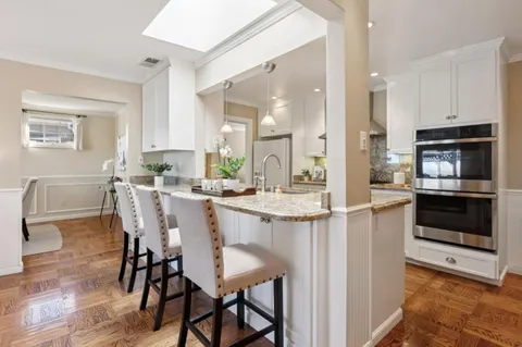 a large kitchen with a table and chairs