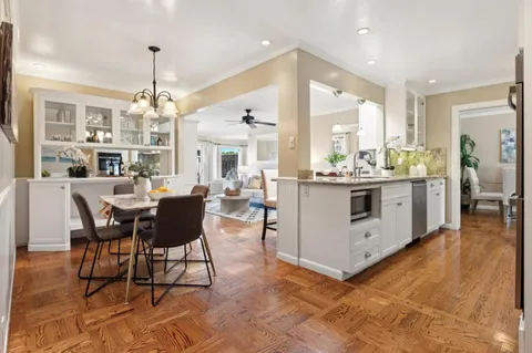 a kitchen with stainless steel appliances kitchen island granite countertop a stove a sink and a refrigerator