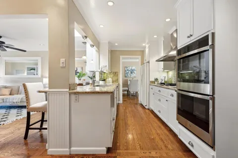 a kitchen with sink stove and cabinets
