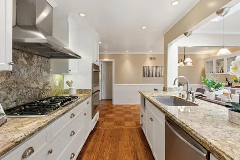 a dining room with wooden floor and breakfast area