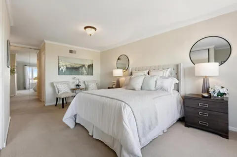 a room with a large window and a rug