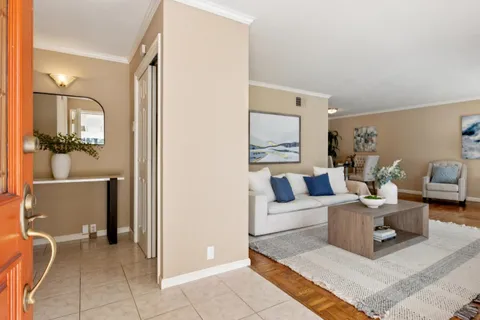 a living room with furniture and a mirror