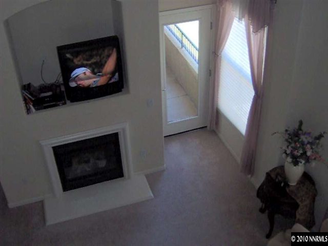 9050 Double R Boulevard, Unit 321 Reno, NV 89521 - Photo 3 of 8 a living room with furniture and a fireplace