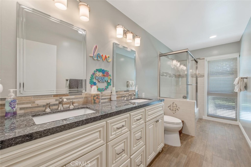 15744 Beaver Run Road Canyon Country, CA 91387 - Photo 16 of 55 a bathroom with a double vanity sink toilet and shower