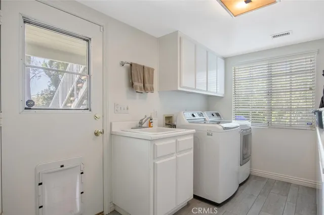 a large kitchen with a stove and a large window