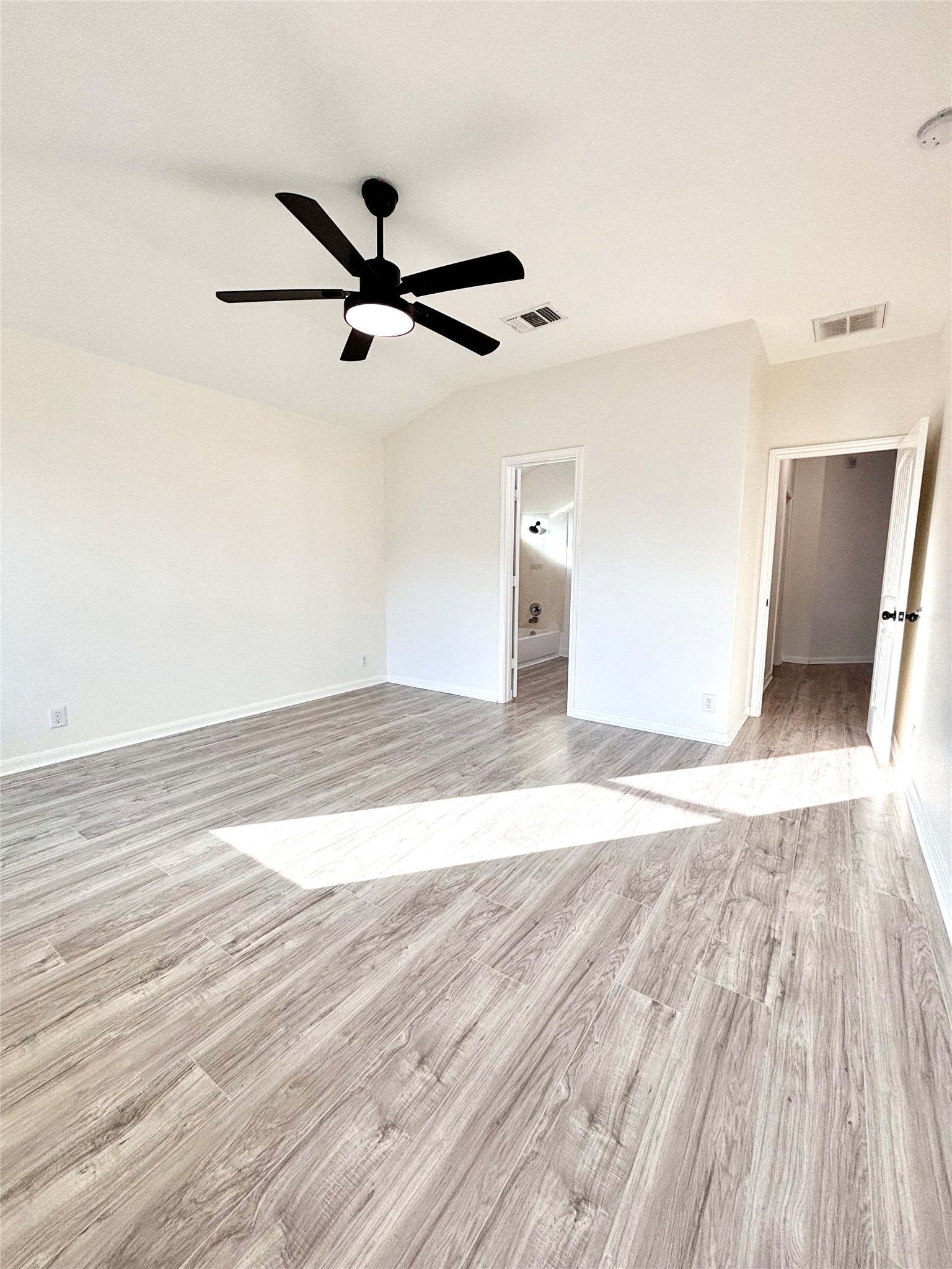606 Old Peak Road Georgetown, TX 78626 - Photo 16 of 23 A well-lit bedroom features durable laminate flooring and a ceiling fan for comfort.