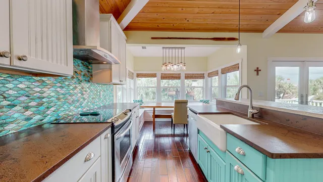 a living room with furniture and a large window with wooden floor