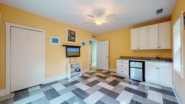 a bathroom with a wooden floor and a sink
