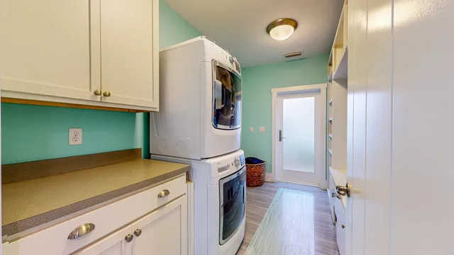 a view of a patio with chairs and potted plants