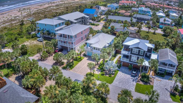 an aerial view of a house with garden space and street view