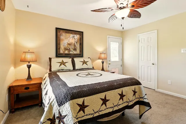 a bedroom with a bed and a chandelier