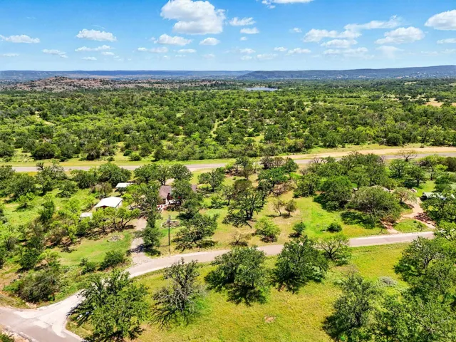 a aerial view of residential houses with outdoor space and swimming pool