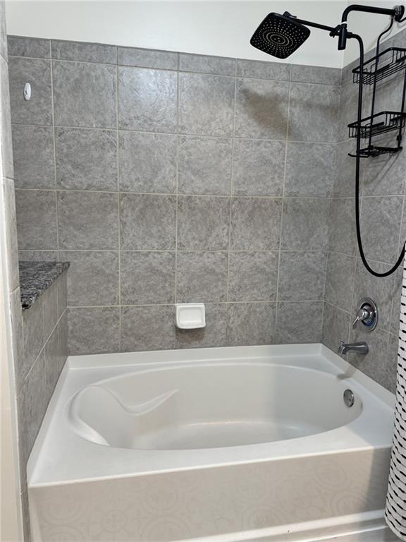 250 Pharr Road Northeast, Unit 601 Atlanta, GA 30305 - Photo 19 of 34 a bathroom with a bath tub and a shower