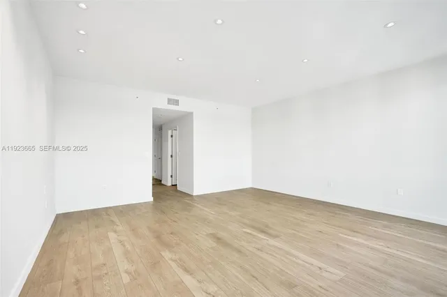 a spacious bathroom with a toilet sink and mirror