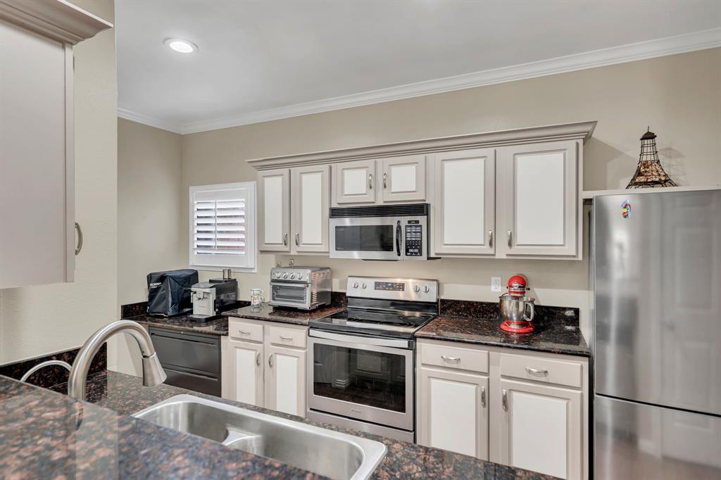 2524 Preston Road, Unit 1205 Plano, TX 75093 - Photo 11 of 25 Kitchen showing cabinets, range, microwave, sink and prep area