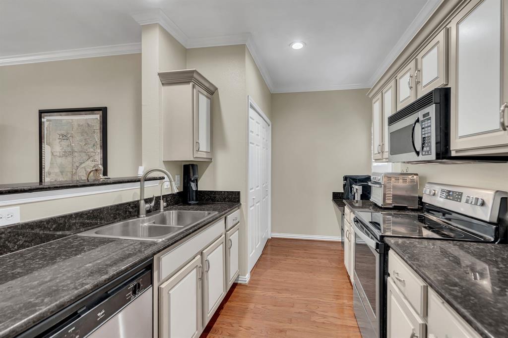 2524 Preston Road, Unit 1205 Plano, TX 75093 - Photo 7 of 25 Looking into kitchen showing granite counters, appliances, cabinets and overlooking dining room