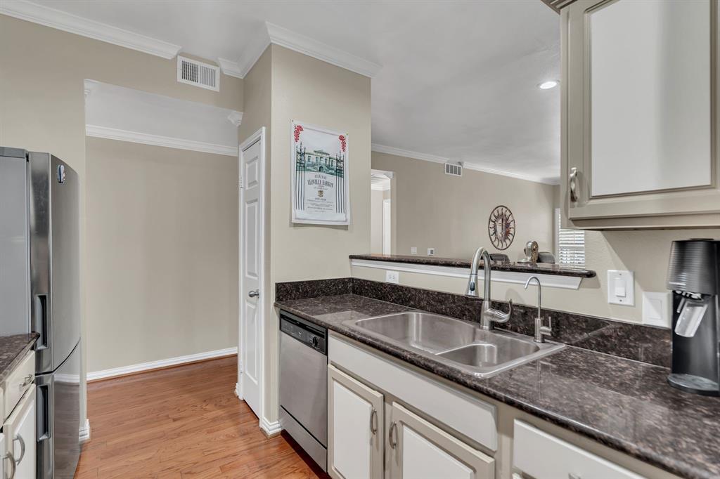 2524 Preston Road, Unit 1205 Plano, TX 75093 - Photo 9 of 25 Kitchen view looking over the kitchen bar, going toward bedroom