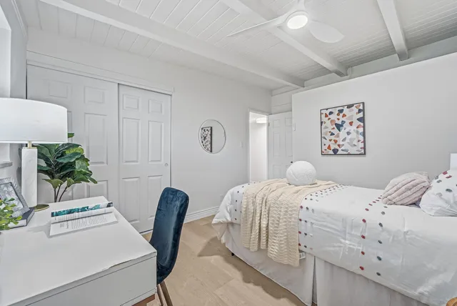 a bedroom with a bed and a chair