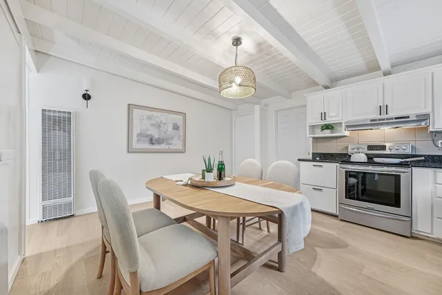 a view of a dining room with furniture wooden floor and chandelier