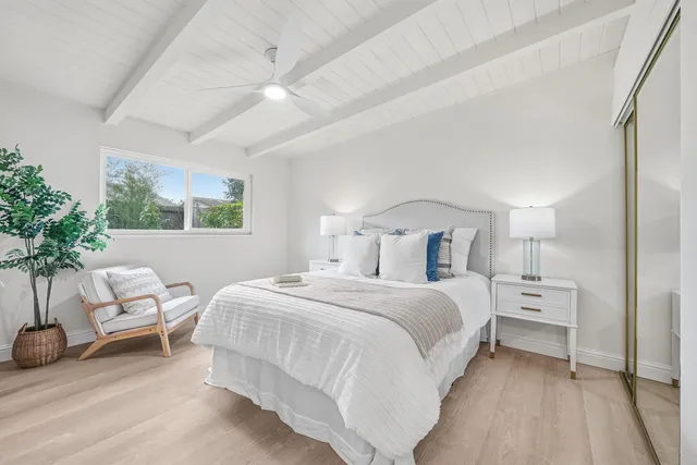a bedroom with bed and a potted plant