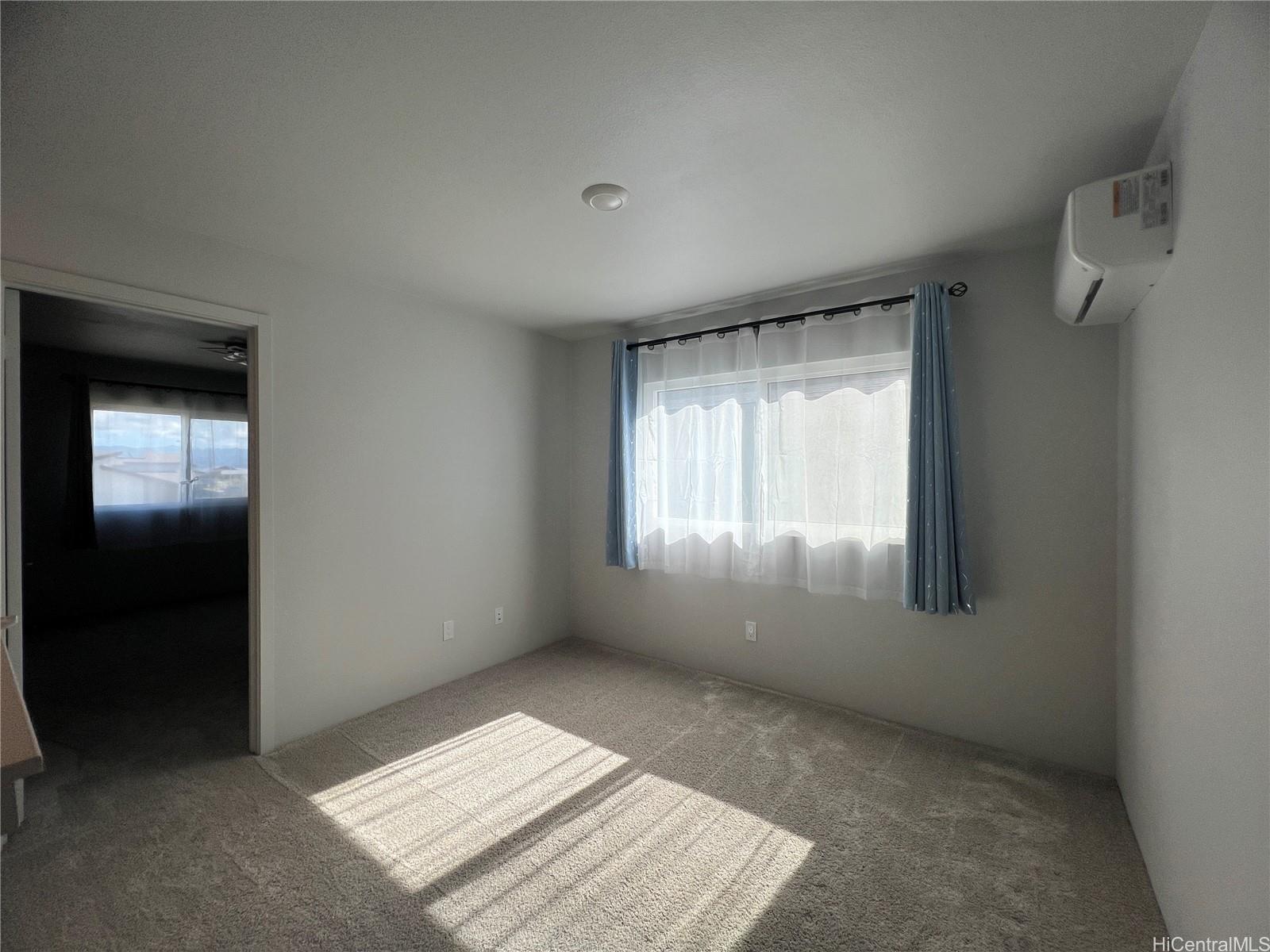 91-1640 Honouliuli Street, Unit 66 Ewa Beach, HI 96706 - Photo 12 of 20 an empty room with windows