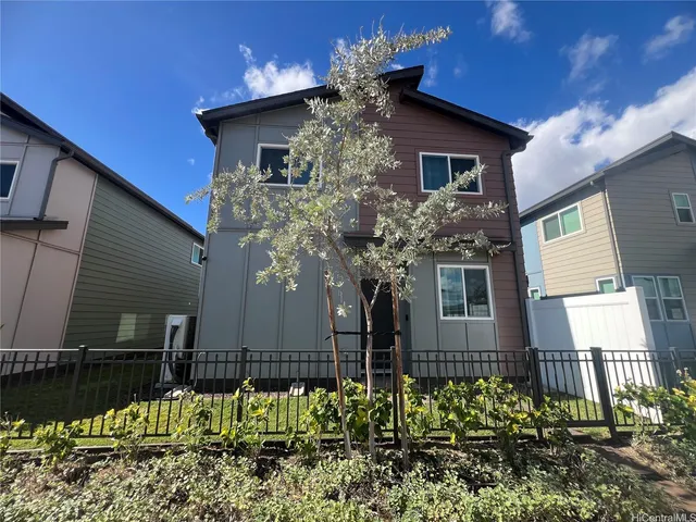 a house that has a tree in front of the house