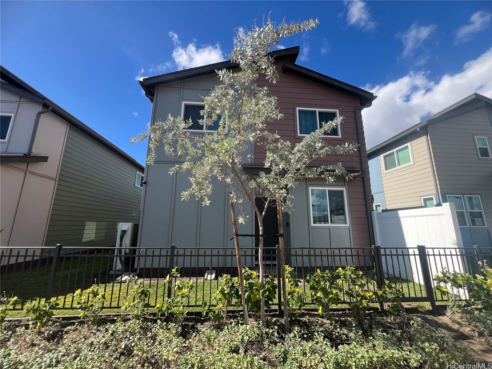 91-1640 Honouliuli Street, Unit 66 Ewa Beach, HI 96706 - Photo 17 of 20 a house that has a tree in front of the house