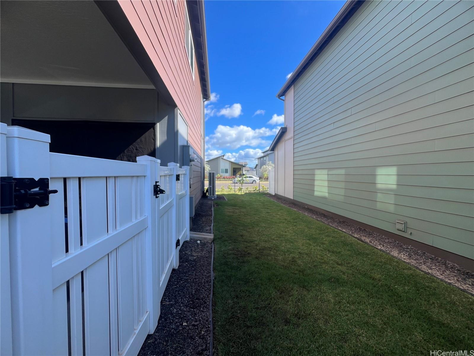 91-1640 Honouliuli Street, Unit 66 Ewa Beach, HI 96706 - Photo 20 of 20 a view of a house with a backyard
