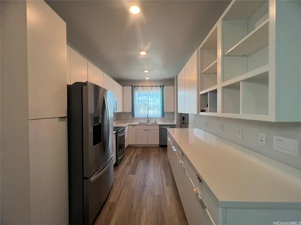 a kitchen with a refrigerator and a sink